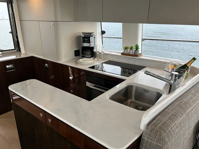 Slide: The Image of Luxurious kitchen interior of 2024 Fairline Squadron 68 yacht with modern appliances and sea view. - 9