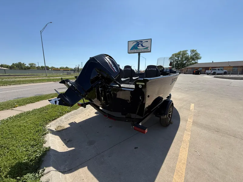Slide: The Image of 2025 Lund 1650 Rebel XL SS boat parked outdoors on a sunny day. - 2