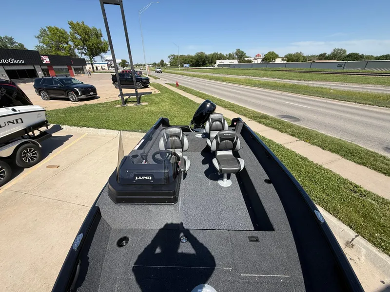 Slide: The Image of 2025 Lund 1650 Rebel XL SS boat parked on a sunny day near a road. - 5