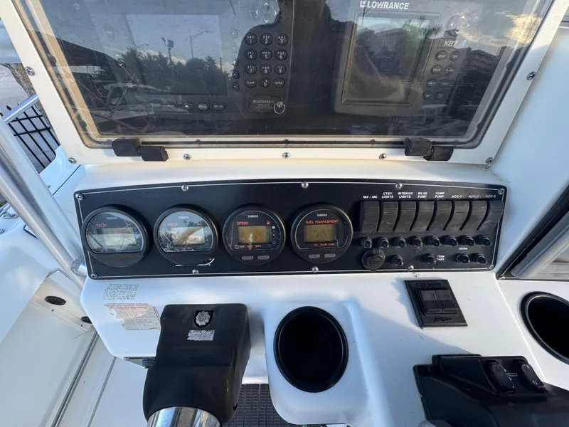 Slide: The Image of Control panel of a 2000 Boston Whaler 26 Outrage boat with gauges and switches. - 10