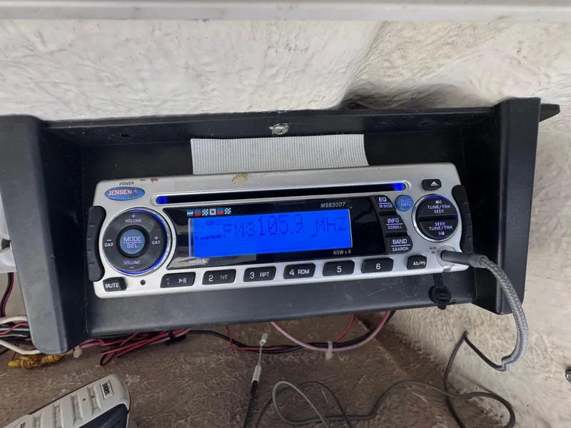 Slide: The Image of Boat stereo system on a 2000 Boston Whaler 26 Outrage, displaying FM radio frequency. - 12