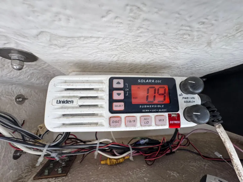 Slide: The Image of Uniden marine radio on 2000 Boston Whaler 26 Outrage boat dashboard. - 13