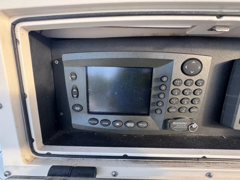 Slide: The Image of Control panel of a 2000 Boston Whaler 26 Outrage boat, featuring navigation equipment. - 18