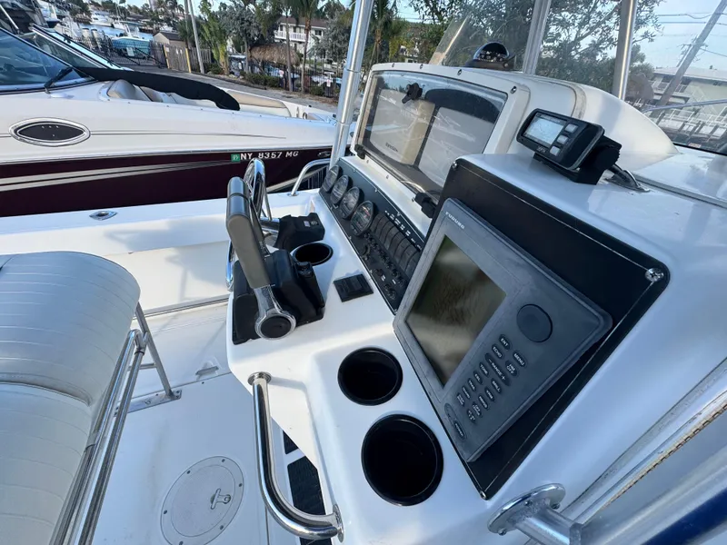 Slide: The Image of Control panel of a 2000 Boston Whaler 26 Outrage boat with navigation equipment. - 21