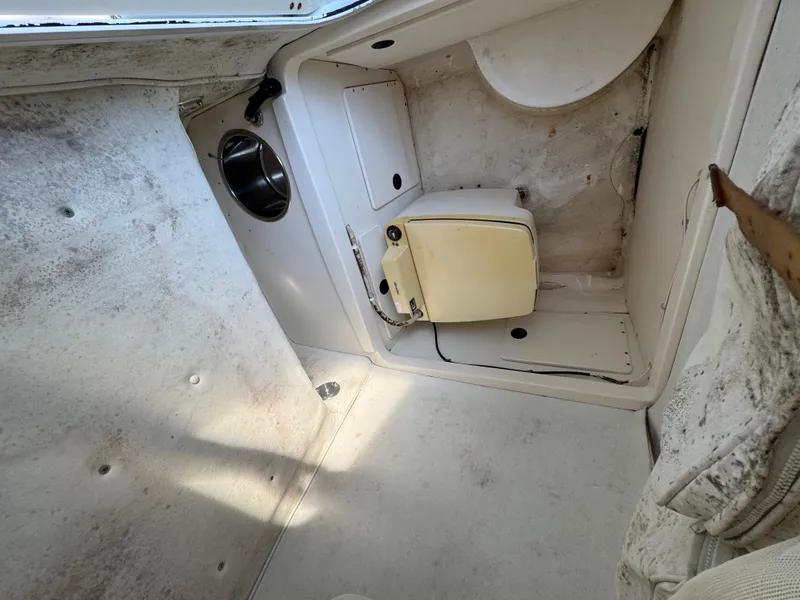 Slide: The Image of Interior of a 2000 Boston Whaler 26 Outrage boat, featuring a compact cabin space. - 24