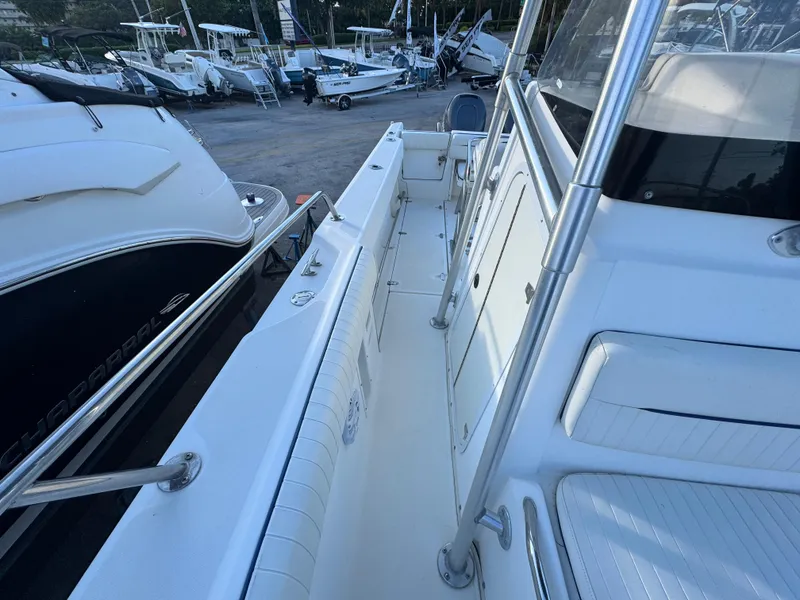 Slide: The Image of Boston Whaler 26 Outrage 2000 model, docked with other boats in a marina. - 25