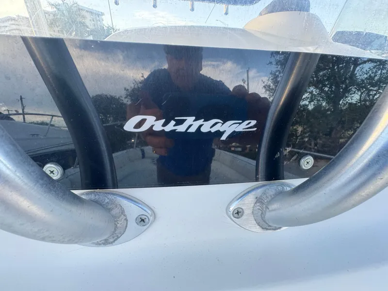 Slide: The Image of Boston Whaler 26 Outrage 2000 model, close-up of logo and railing. - 27