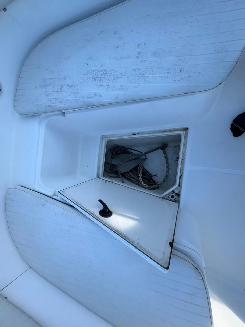 Slide: The Image of 2000 Boston Whaler 26 Outrage boat deck with open storage compartment. - 31