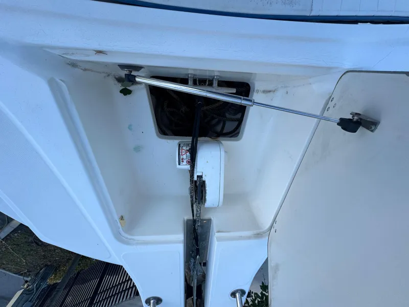 Slide: The Image of 2000 Boston Whaler 26 Outrage anchor compartment with hydraulic support. - 34