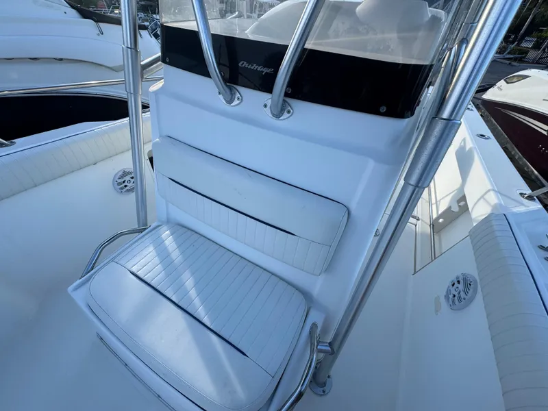 Slide: The Image of Boston Whaler 26 Outrage 2000 boat interior with white seating and stainless steel frame. - 37