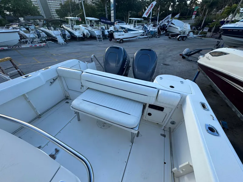 Slide: The Image of 2000 Boston Whaler 26 Outrage boat with dual engines, docked among other boats. - 4