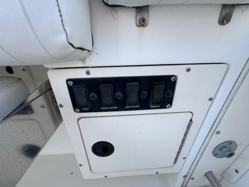 Slide: The Image of Control panel on a 2000 Boston Whaler 26 Outrage boat, featuring labeled switches. - 41