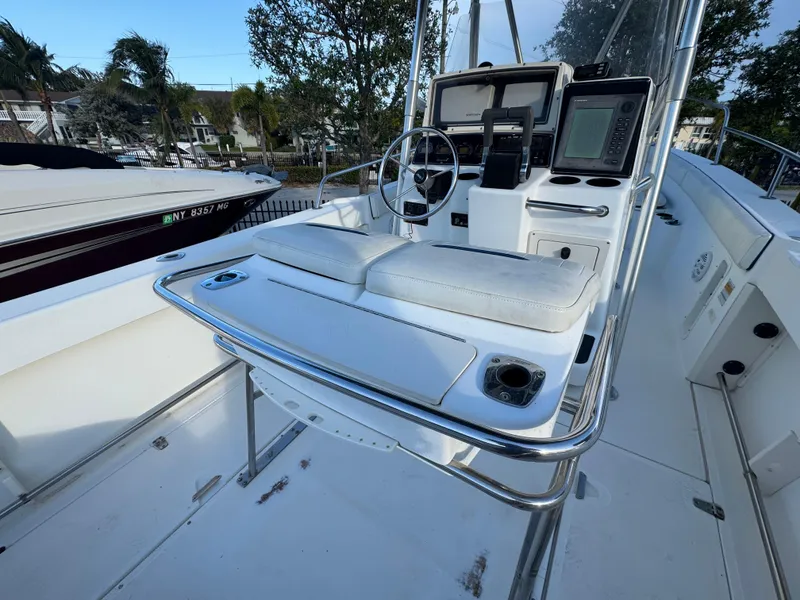 Slide: The Image of 2000 Boston Whaler 26 Outrage boat console with seating and navigation equipment. - 43