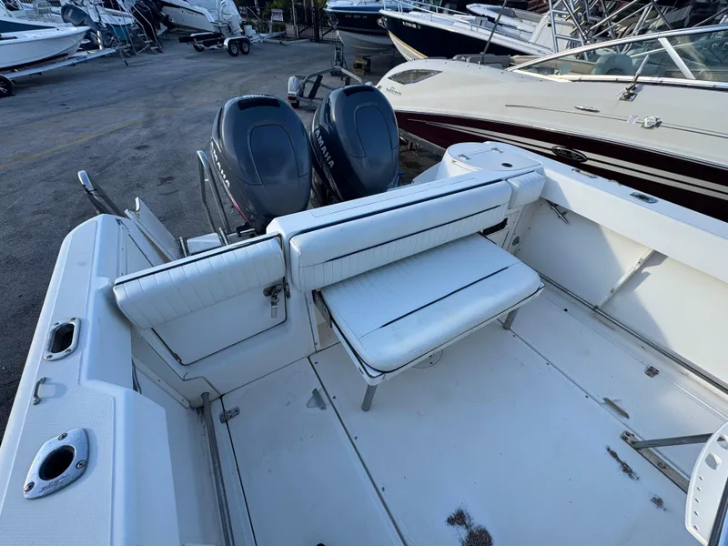 Slide: The Image of 2000 Boston Whaler 26 Outrage boat interior with seating and dual engines. - 45