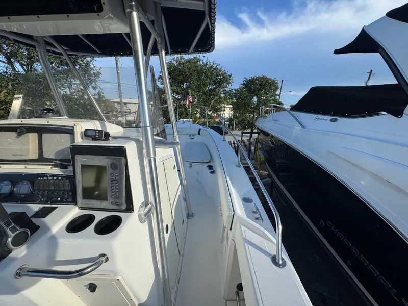 Slide: The Image of Boston Whaler 26 Outrage 2000 model, featuring a sleek deck and modern navigation equipment. - 48