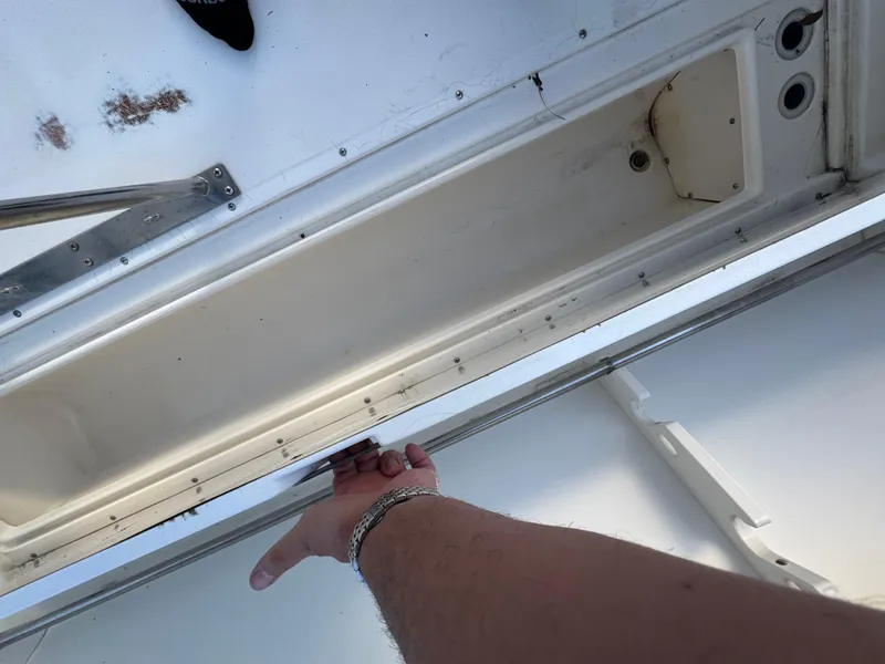 Slide: The Image of Boston Whaler 26 Outrage 2000 boat interior with open storage compartment. - 49