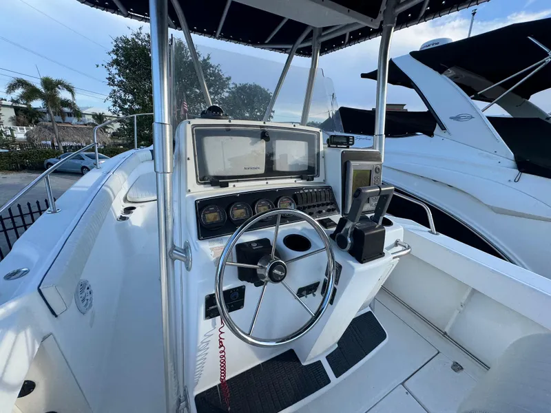 Slide: The Image of 2000 Boston Whaler 26 Outrage boat cockpit with steering wheel and navigation equipment. - 6