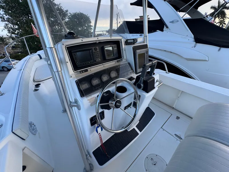 Slide: The Image of Boston Whaler 26 Outrage 2000 boat cockpit with steering wheel and navigation equipment. - 9