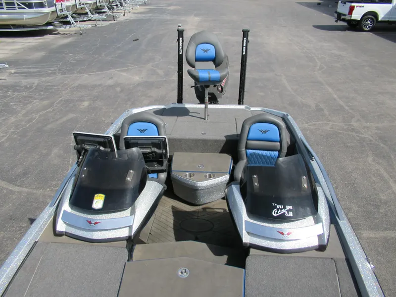 Slide: The Image of 2021 Vexus VX20 boat interior with dual consoles and seating, parked on a lot. - 3