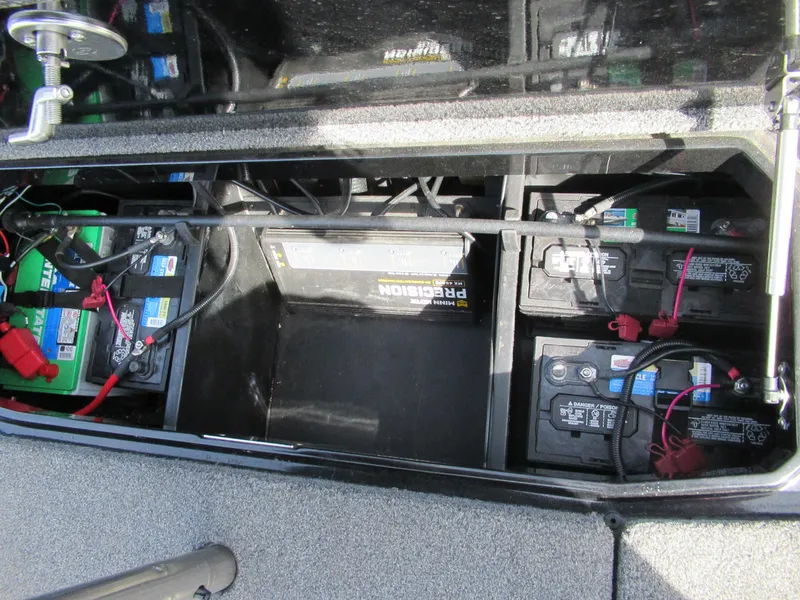 Slide: The Image of 2021 Vexus VX20 boat battery compartment with multiple batteries and wiring. - 7