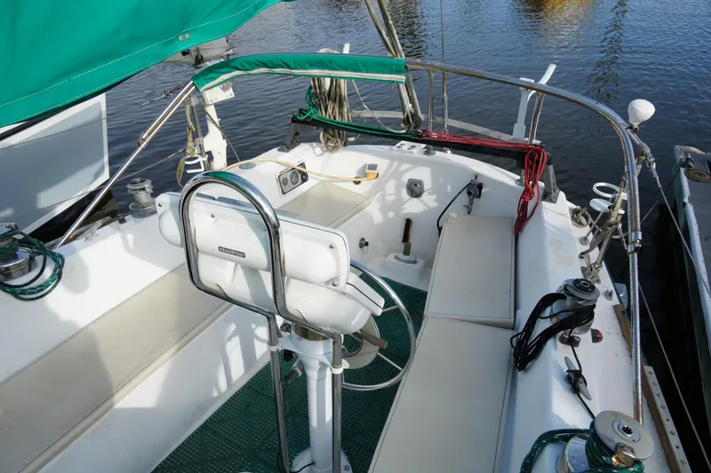 Slide: The Image of 1974 Morgan 33 Out Island sailboat cockpit with green accents and seating. - 10