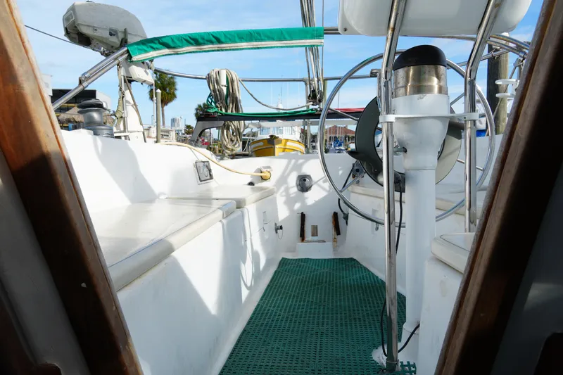 Slide: The Image of 1974 Morgan 33 Out Island sailboat cockpit with green canopy and steering wheel. - 14