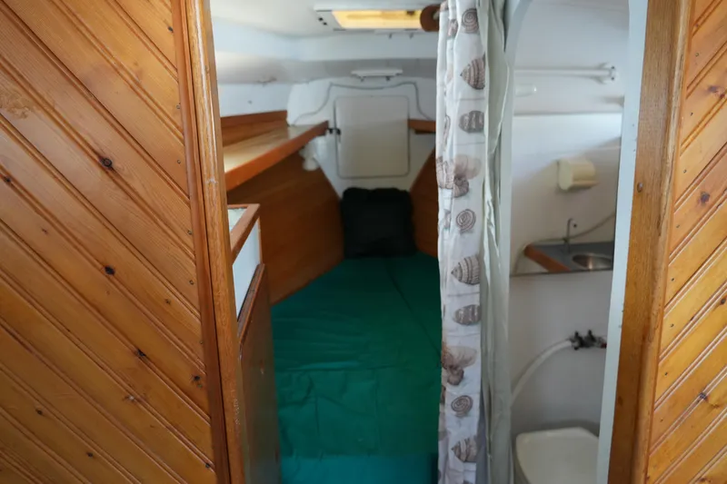 Slide: The Image of 1974 Morgan 33 Out Island cabin interior with wood paneling and compact amenities. - 16