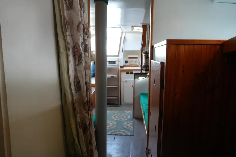 Slide: The Image of Interior view of a 1974 Morgan 33 Out Island sailboat, featuring cozy cabin space. - 17