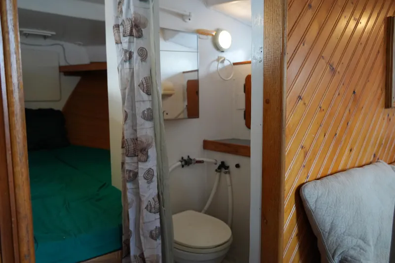 Slide: The Image of 1974 Morgan 33 Out Island interior with bathroom and sleeping area. - 18
