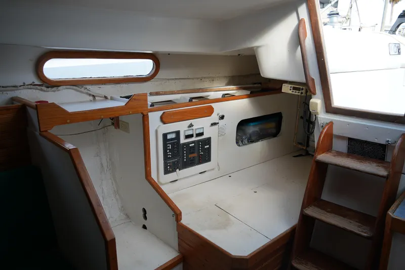 Slide: The Image of Interior of a 1974 Morgan 33 Out Island sailboat, featuring wooden accents and control panels. - 24
