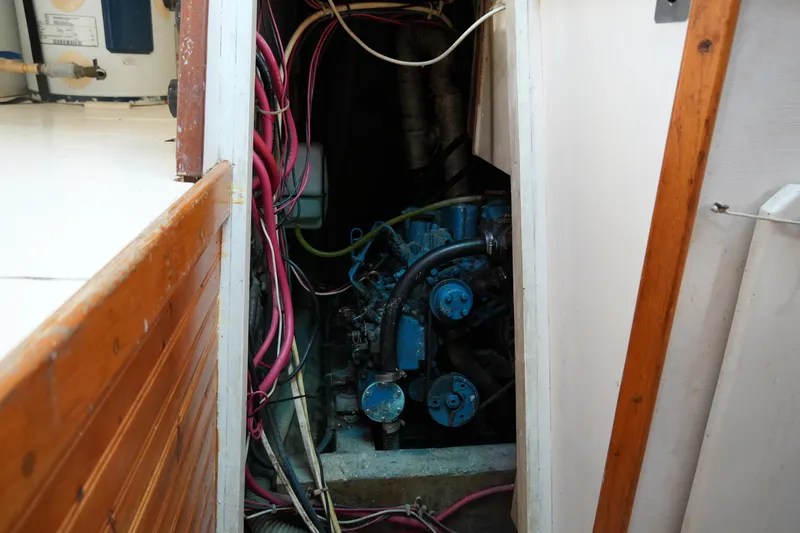 Slide: The Image of Engine compartment of a 1974 Morgan 33 Out Island sailboat with visible wiring and components. - 26