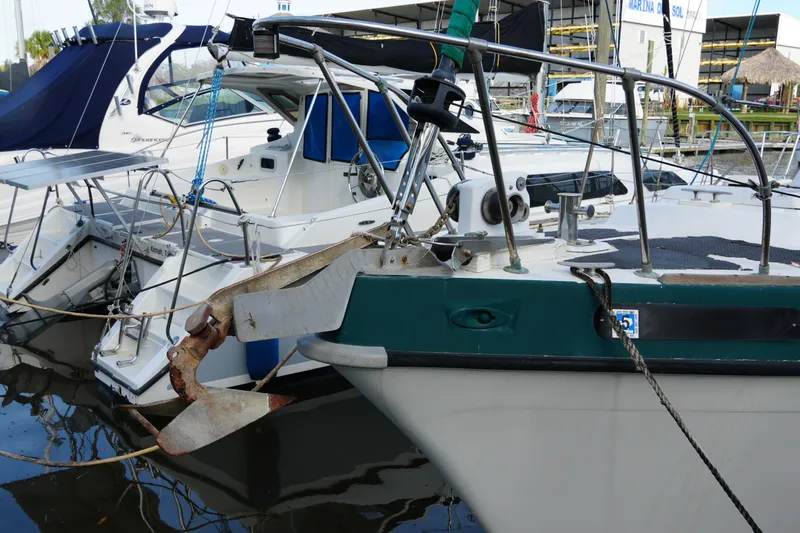 Slide: The Image of 1974 Morgan 33 Out Island sailboat docked in a marina, featuring a prominent anchor. - 4