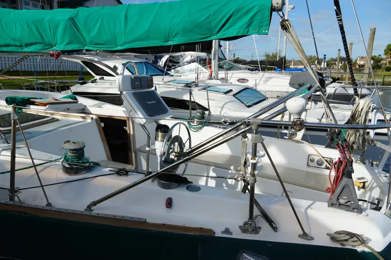 Slide: The Image of 1974 Morgan 33 Out Island sailboat docked with green sail cover. - 9