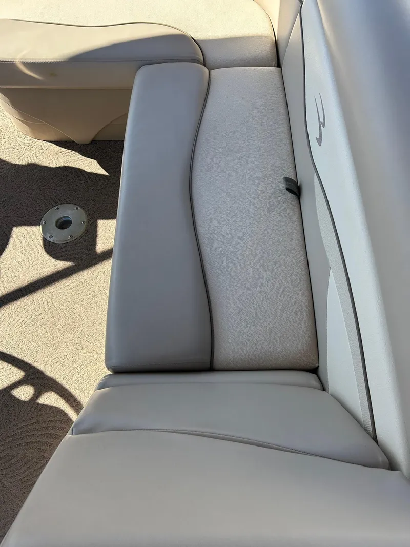 Slide: The Image of 2012 Bennington 20SLi boat interior with beige seating and carpeted floor. - 14