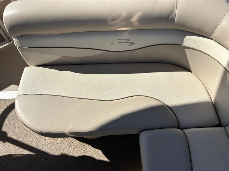 Slide: The Image of 2012 Bennington 20SLi boat interior with beige cushioned seating. - 18