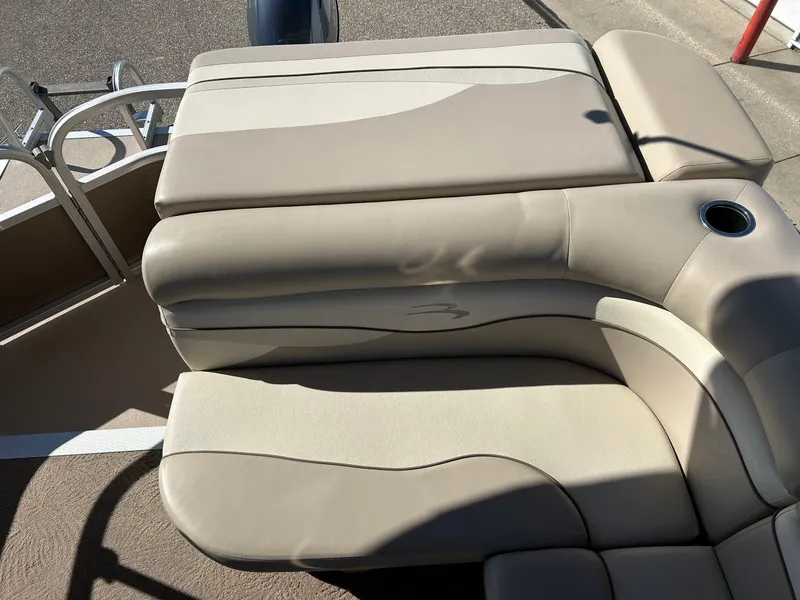 Slide: The Image of 2012 Bennington 20SLi boat with beige cushioned seating and cup holder. - 19