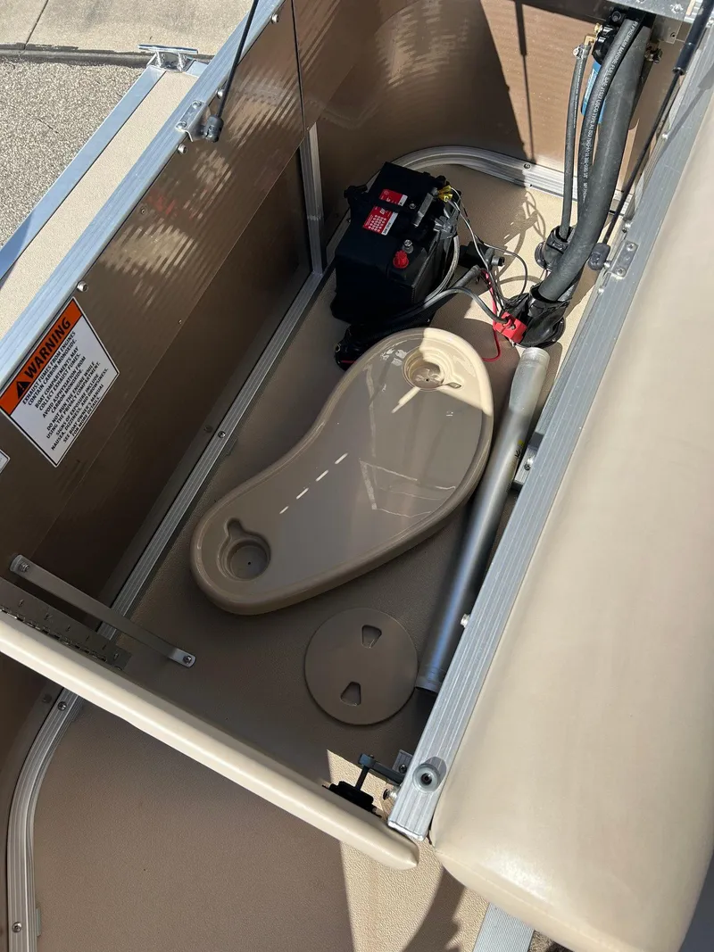 Slide: The Image of 2012 Bennington 20SLi boat interior showing battery compartment and seating area. - 21