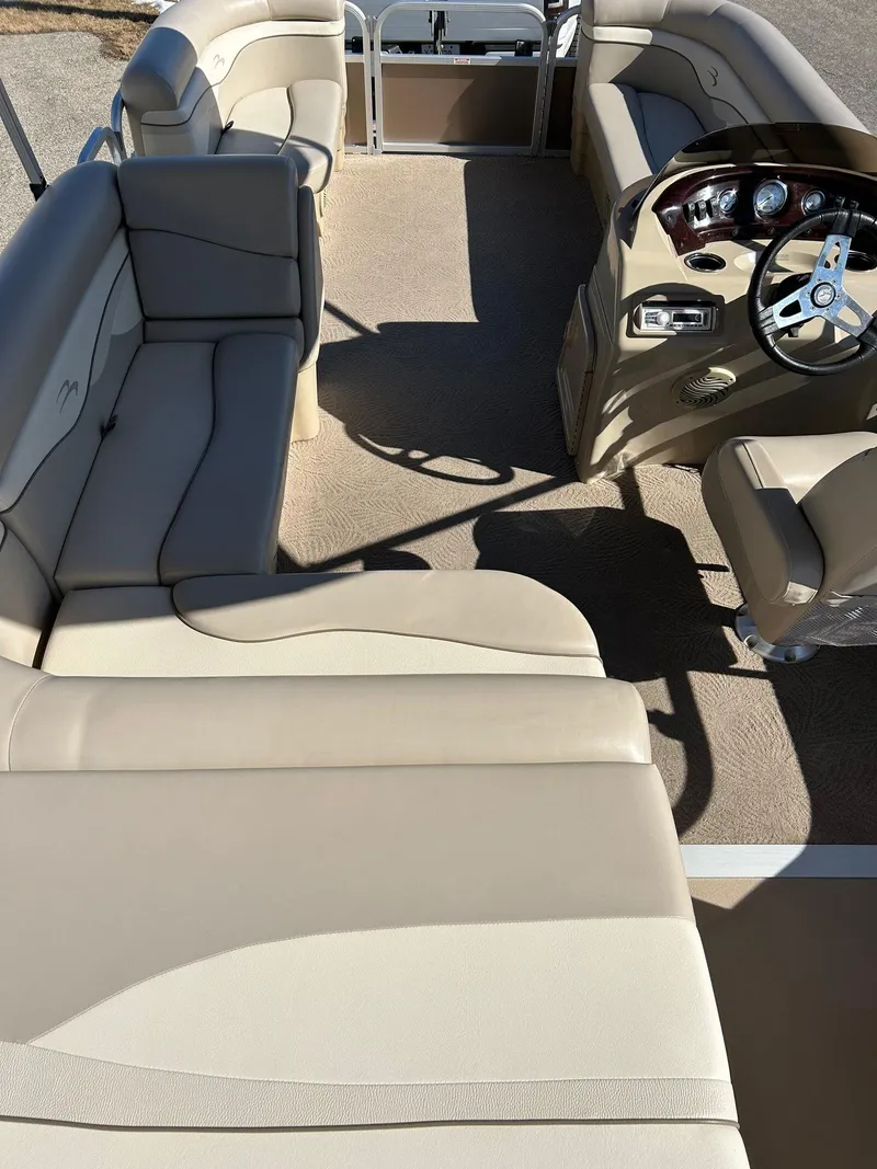 Slide: The Image of 2012 Bennington 20SLi pontoon boat interior with beige seating and steering console. - 22
