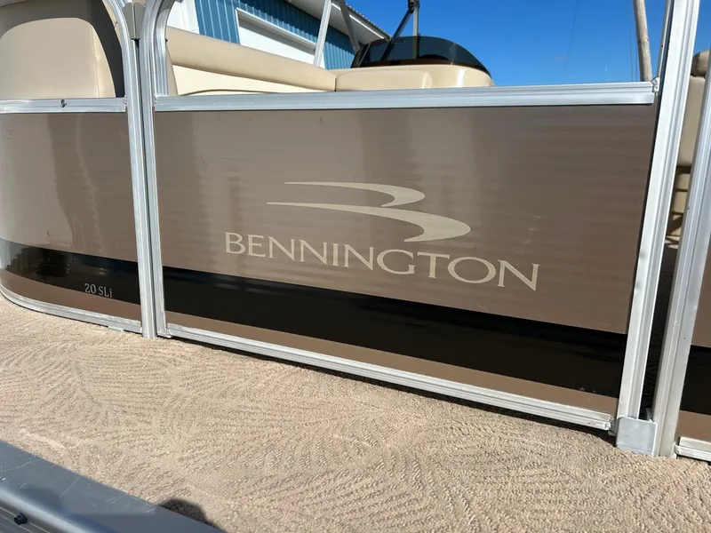 Slide: The Image of 2012 Bennington 20SLi pontoon boat with beige and black exterior design. - 24