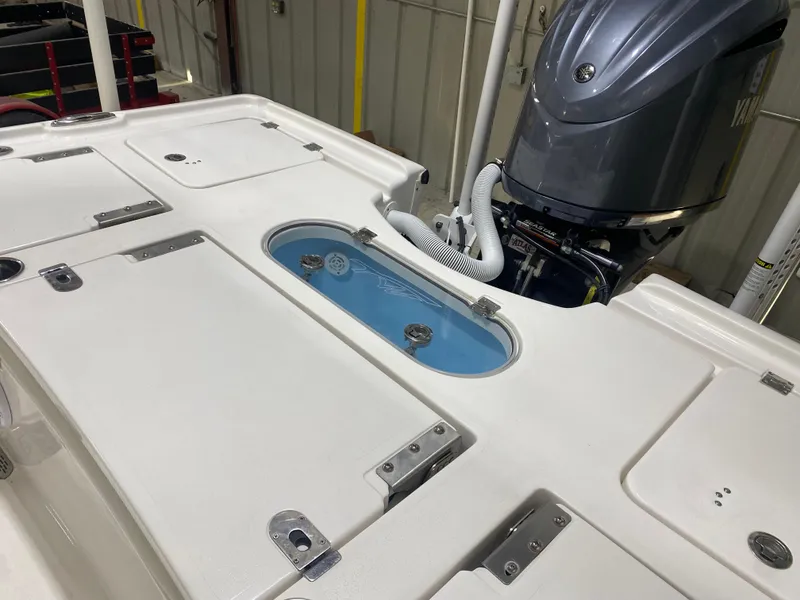 Slide: The Image of 2022 Tidewater 2500 Carolina Bay boat deck with storage compartments and motor. - 15