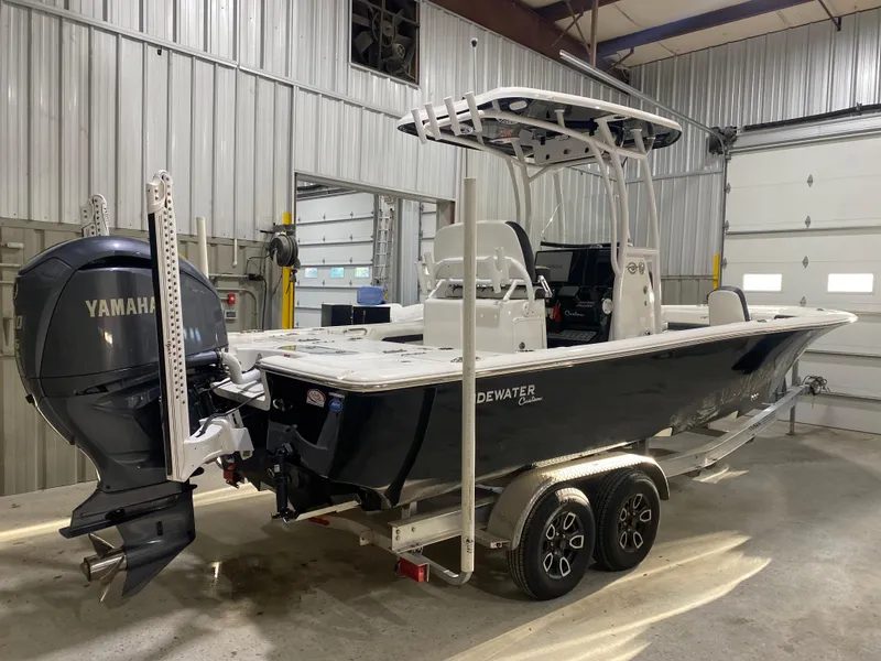 Slide: The Image of 2022 Tidewater 2500 Carolina Bay boat with Yamaha engine on trailer in garage. - 3