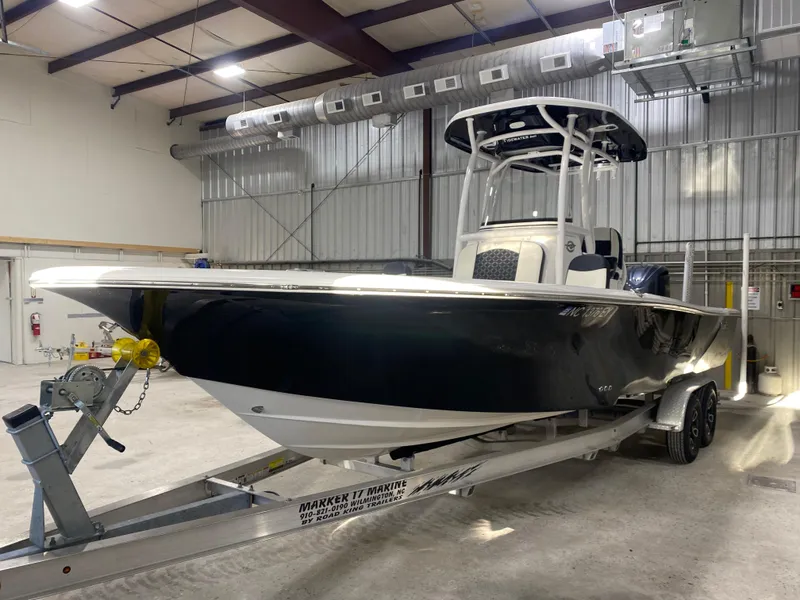 Slide: The Image of 2022 Tidewater 2500 Carolina Bay boat on trailer in warehouse setting. - 5
