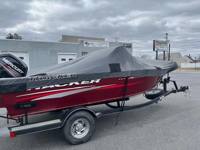 Slide: The Image of 2018 Tracker Pro Guide V-175 WT boat on trailer, covered, parked outdoors. - 3