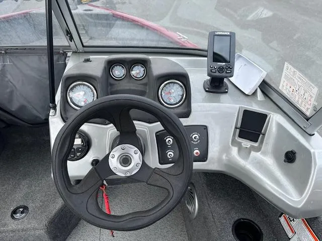 Slide: The Image of 2018 Tracker Pro Guide V-175 WT boat dashboard with steering wheel and navigation system. - 7