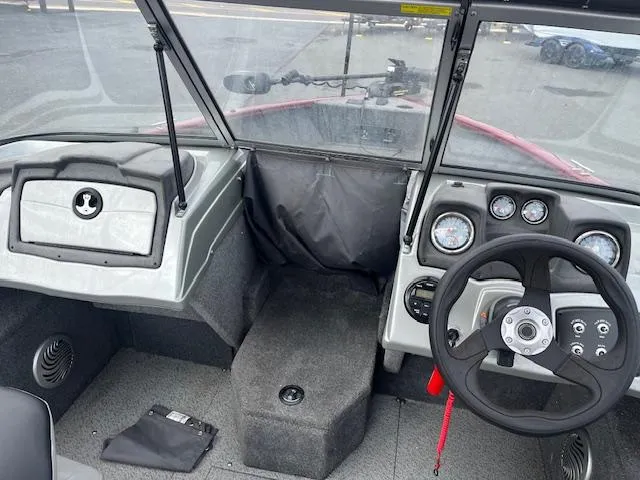 Slide: The Image of 2018 Tracker Pro Guide V-175 WT boat interior with steering wheel and dashboard controls. - 9