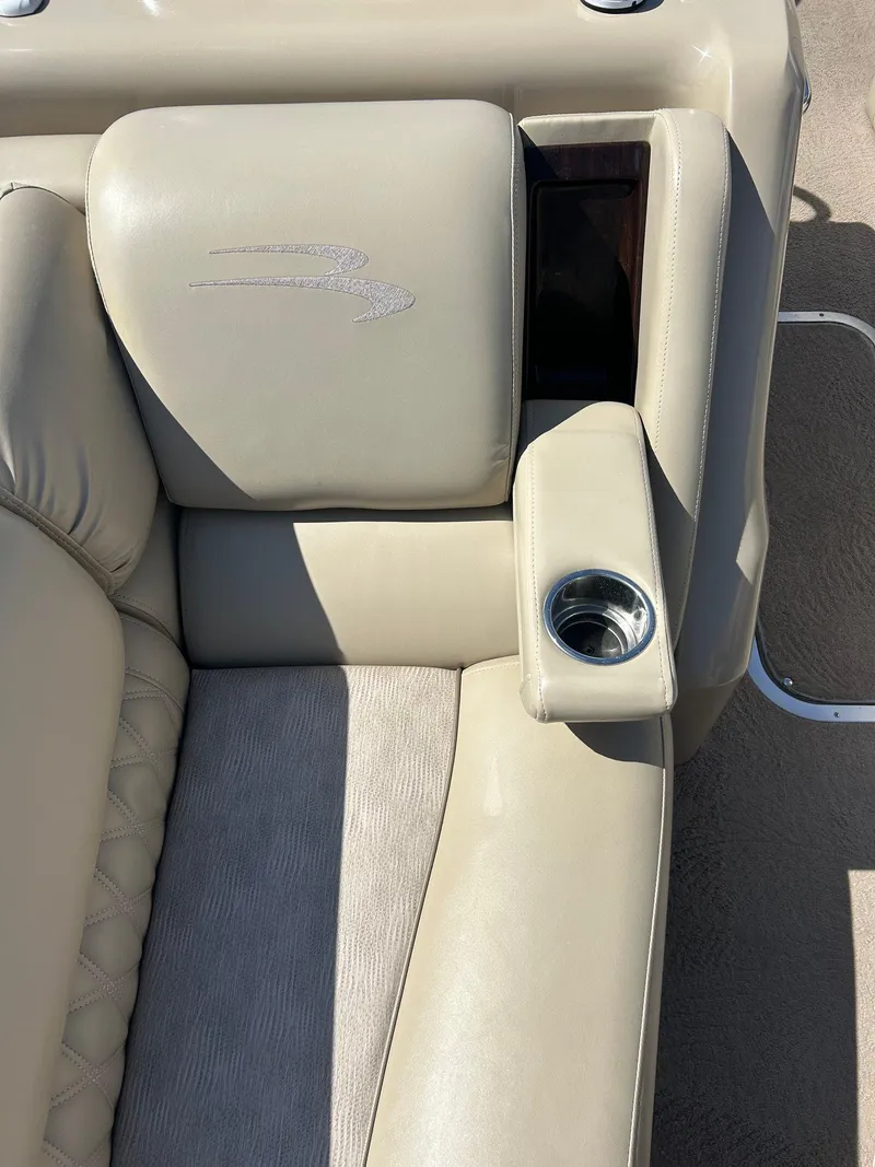 Slide: The Image of 2012 Bennington 2250RCL boat seat with beige upholstery and built-in cup holder. - 18
