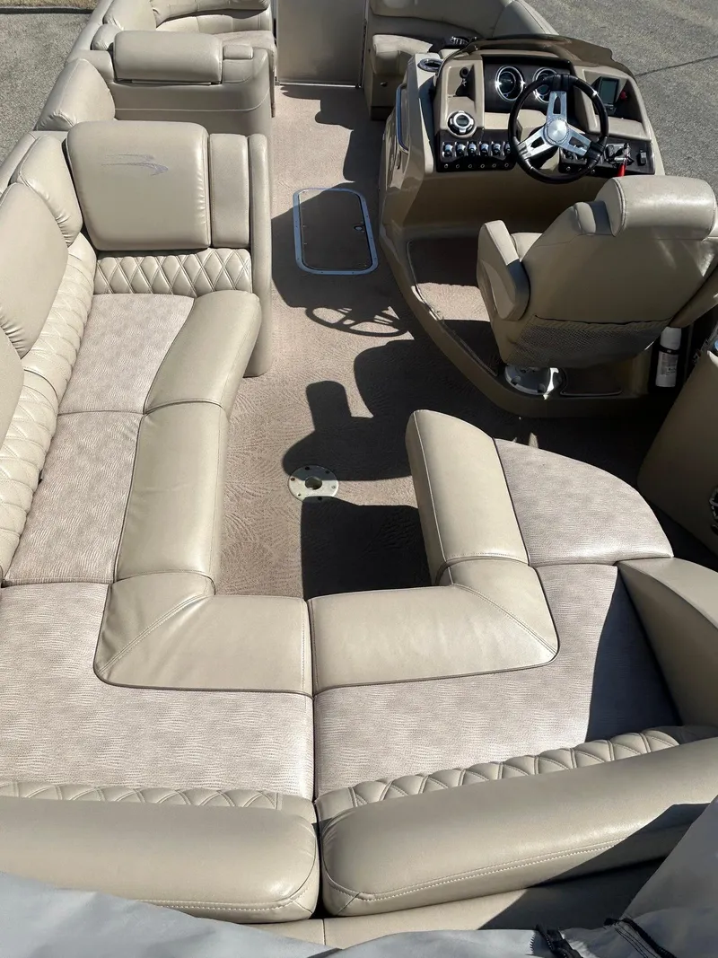 Slide: The Image of 2012 Bennington 2250RCL pontoon boat interior with beige seating and helm. - 27