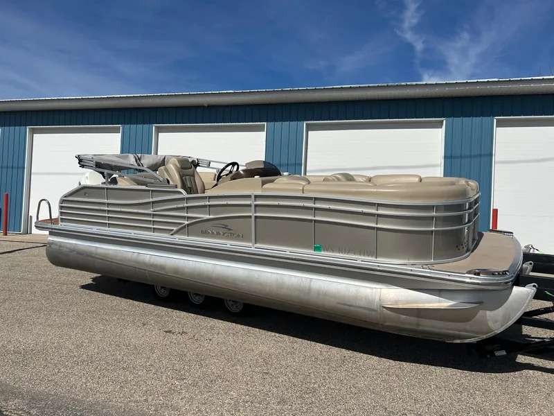 Slide: The Image of 2012 Bennington 2250RCL pontoon boat parked outside blue storage units. - 31