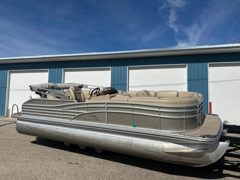 Slide: The Image of 2012 Bennington 2250RCL pontoon boat parked outside blue garage doors. - 32