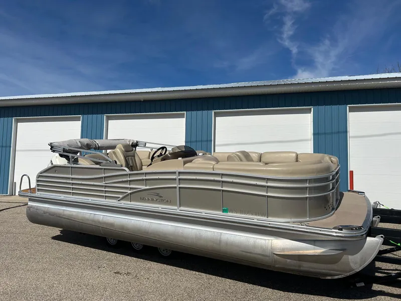 Slide: The Image of 2012 Bennington 2250RCL pontoon boat parked near blue storage units. - 33
